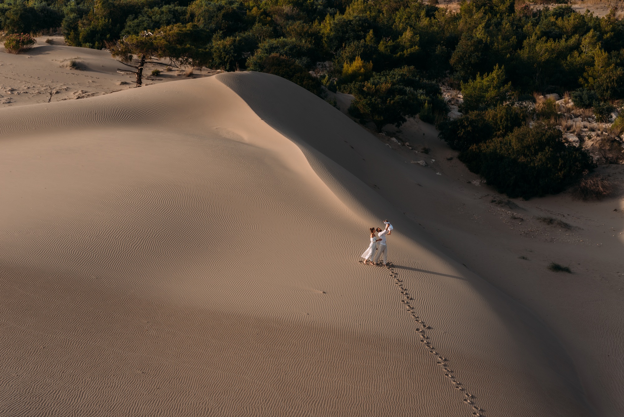 A traveling family. People on a sand dune. Vacation in Dubai. Copy space